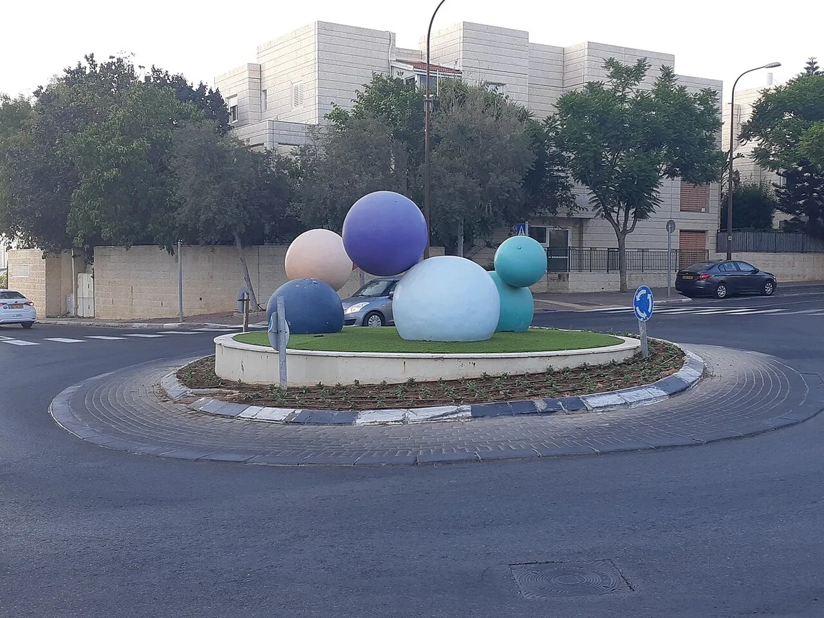 Aryeh Almog's giant coloured balls sculpture on a roundabout in Masuah (Givat C)