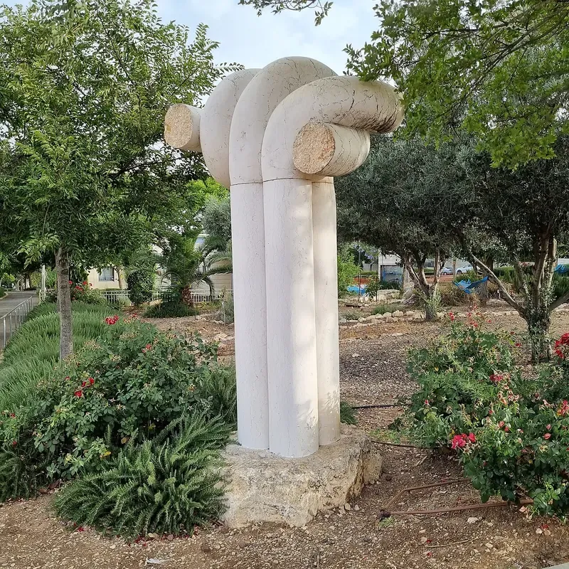 Tanya Preminger's stone sculpture 'Quartet' among trees on Emek Beit She'an St, HaNevi'im